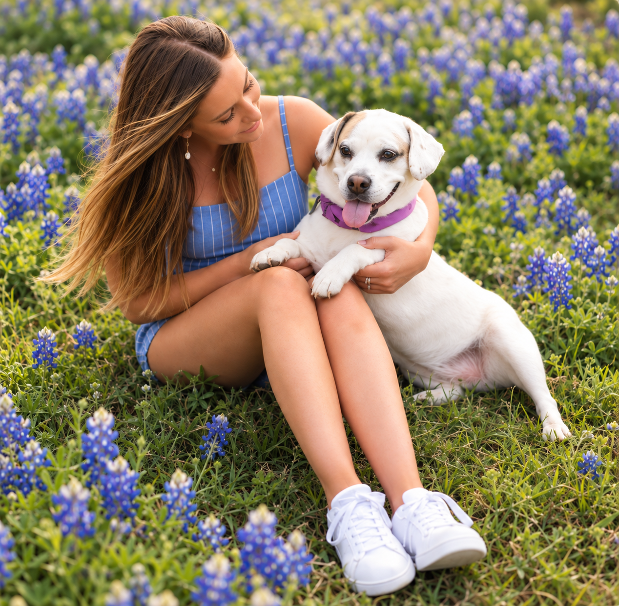 Brittany with a foster pup in a field of bluebonnets